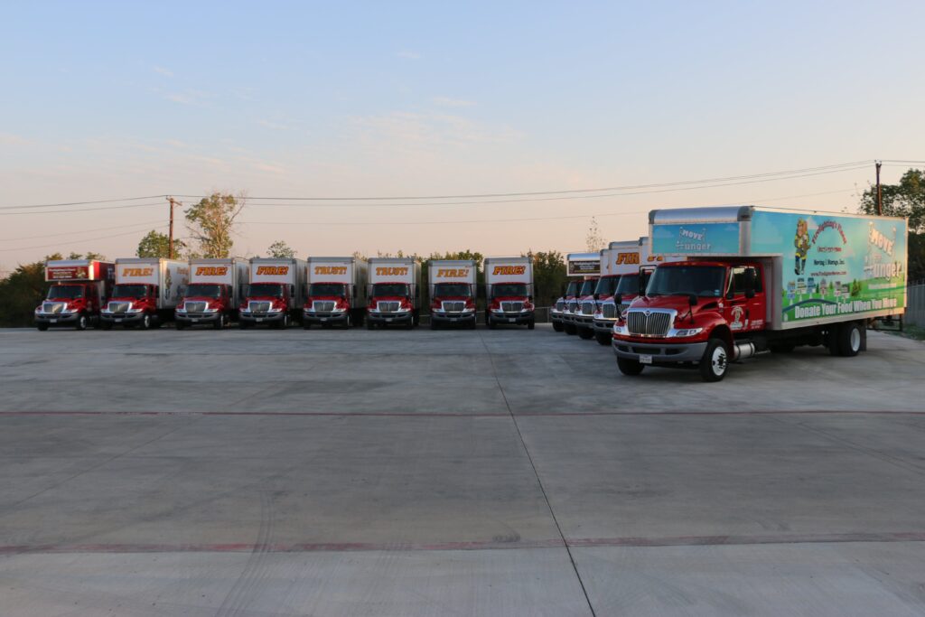 Trucks of Firefighter's Finest Moving & Storage aligned at a parking area in Fort Worth, TX

