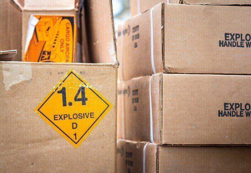 A close up image of gun boxes being stored inside of a storage unit