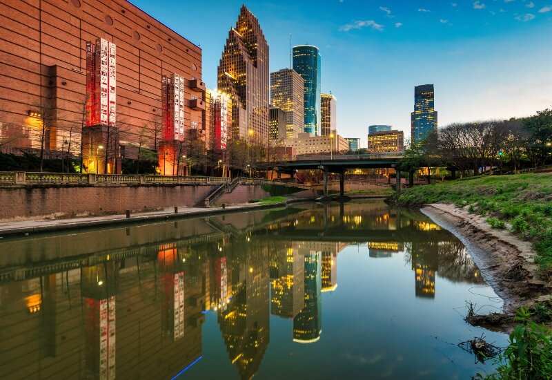 Beautiful view of buildings and a river in Downtown Houston, TX