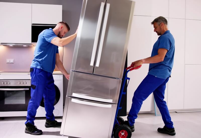People moving a refrigerator in Texas