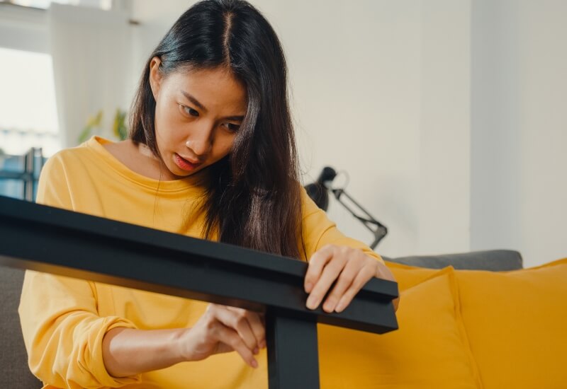 A person taking apart a bed frame in Texas