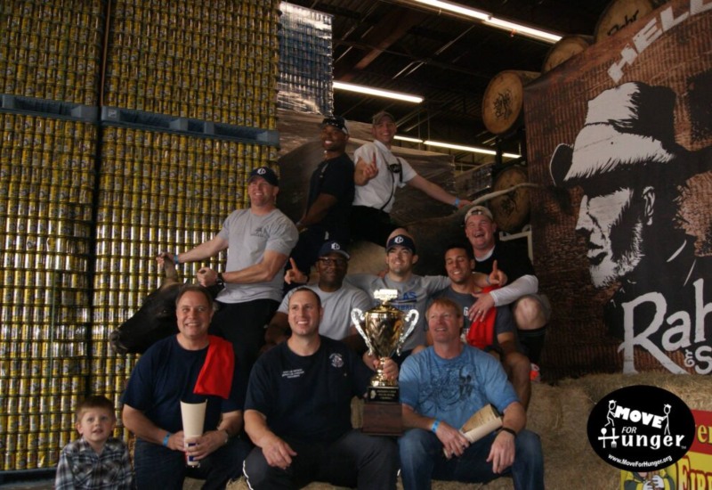 Team holding trophy at Move for Hunger event
